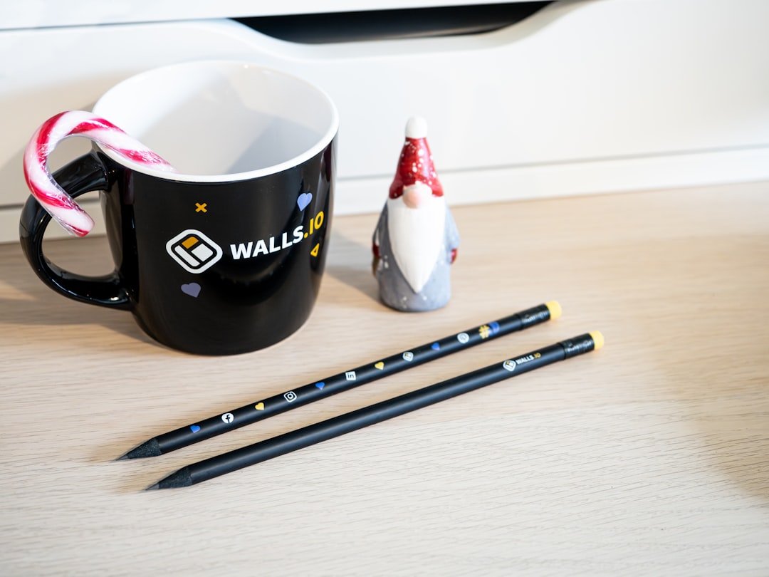 a cup of coffee next to a couple of pencils
